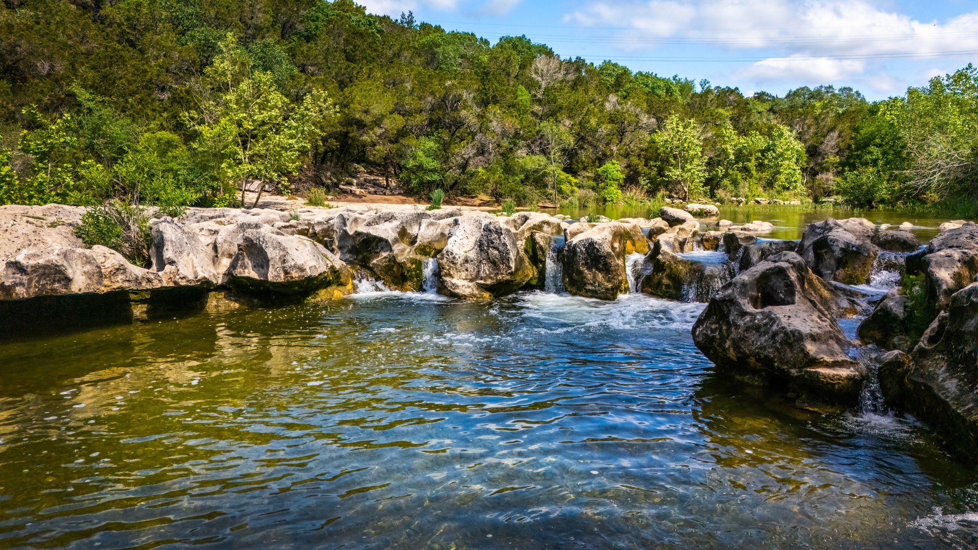 Scenic aerial view of Sculpture Falls via Barton Creek Greenbelt Trail