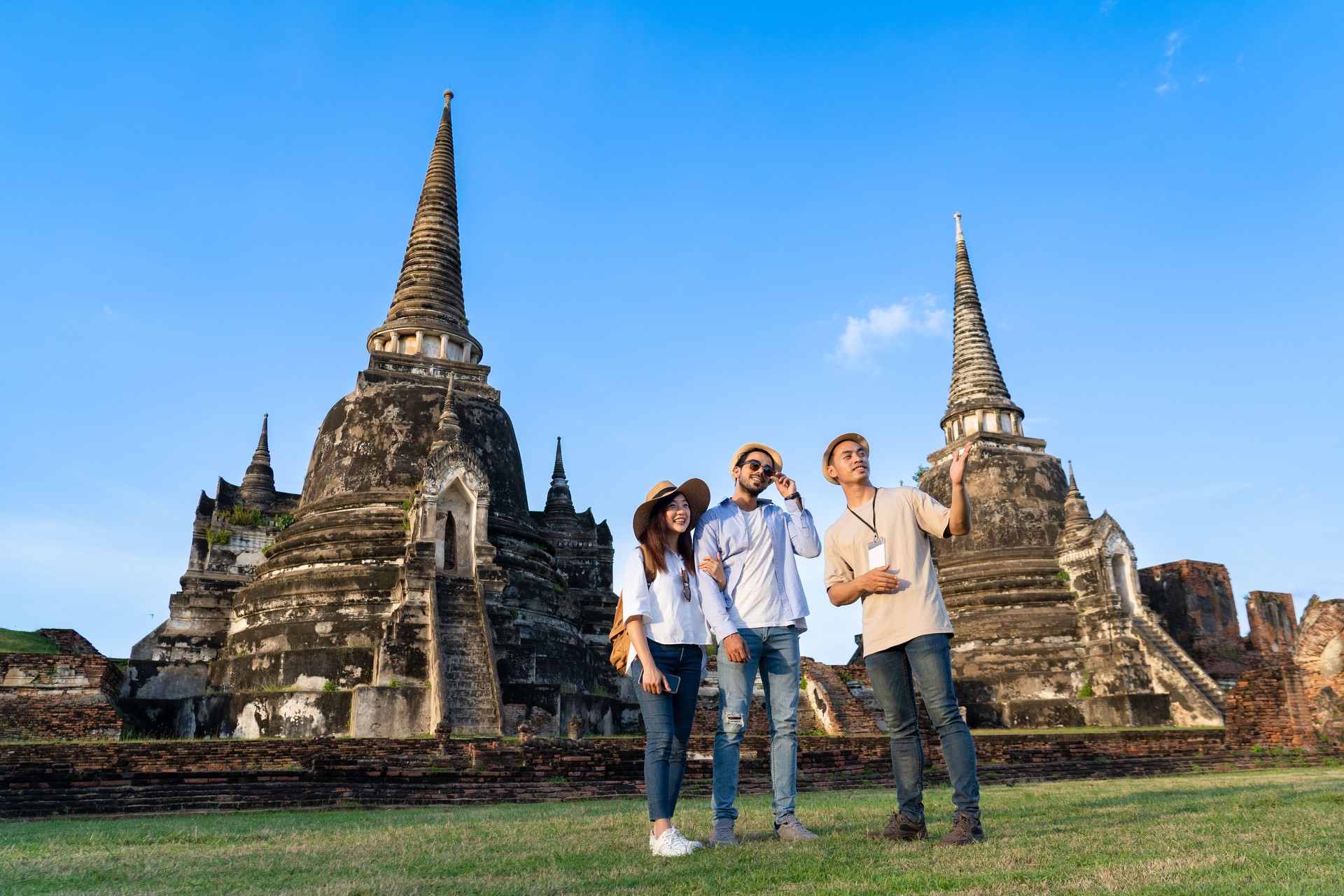 young couple tourist travel to Wat in Ayutthaya with Thai local guide